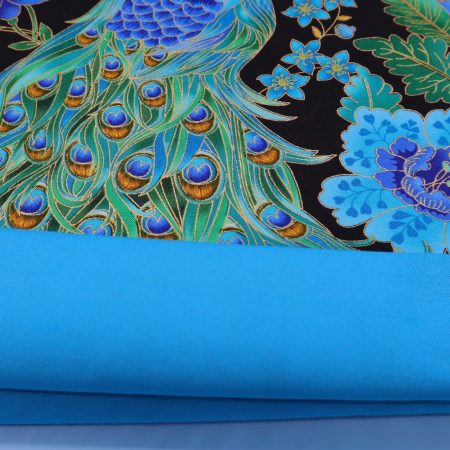 Lining of blue peacock floral cushion cover with vibrant bird design on the front and feather pattern on the reverse