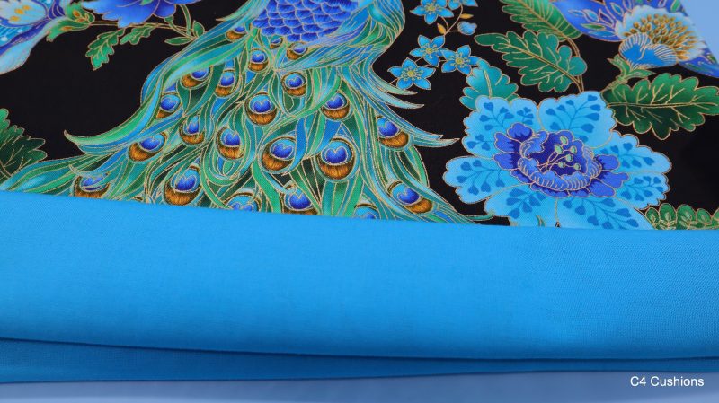 Lining of blue peacock floral cushion cover with vibrant bird design on the front and feather pattern on the reverse