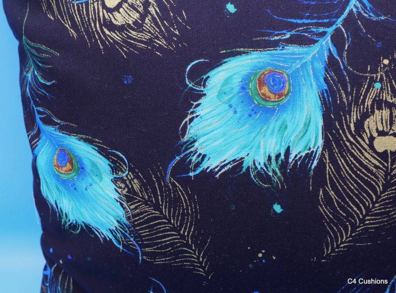 Reverse detail of blue peacock floral cushion cover with vibrant bird design on the front and feather pattern on the reverse