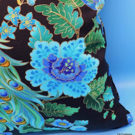 Flower detail of blue peacock floral cushion cover with vibrant bird design on the front and feather pattern on the reverse
