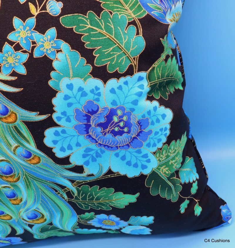 Flower detail of blue peacock floral cushion cover with vibrant bird design on the front and feather pattern on the reverse