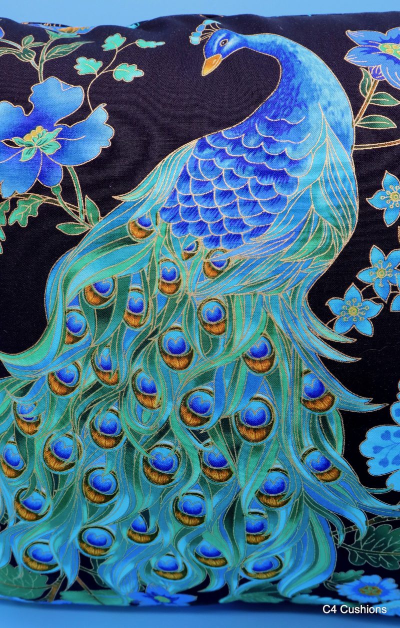 Front detail of blue peacock floral cushion cover with vibrant bird design on the front and feather pattern on the reverse