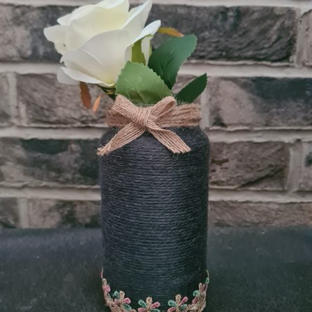 Upcycled glass jar wrapped in dark grey yarn with lace and jute trim