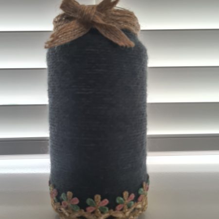 Upcycled glass jar wrapped in dark grey yarn with lace and jute trim