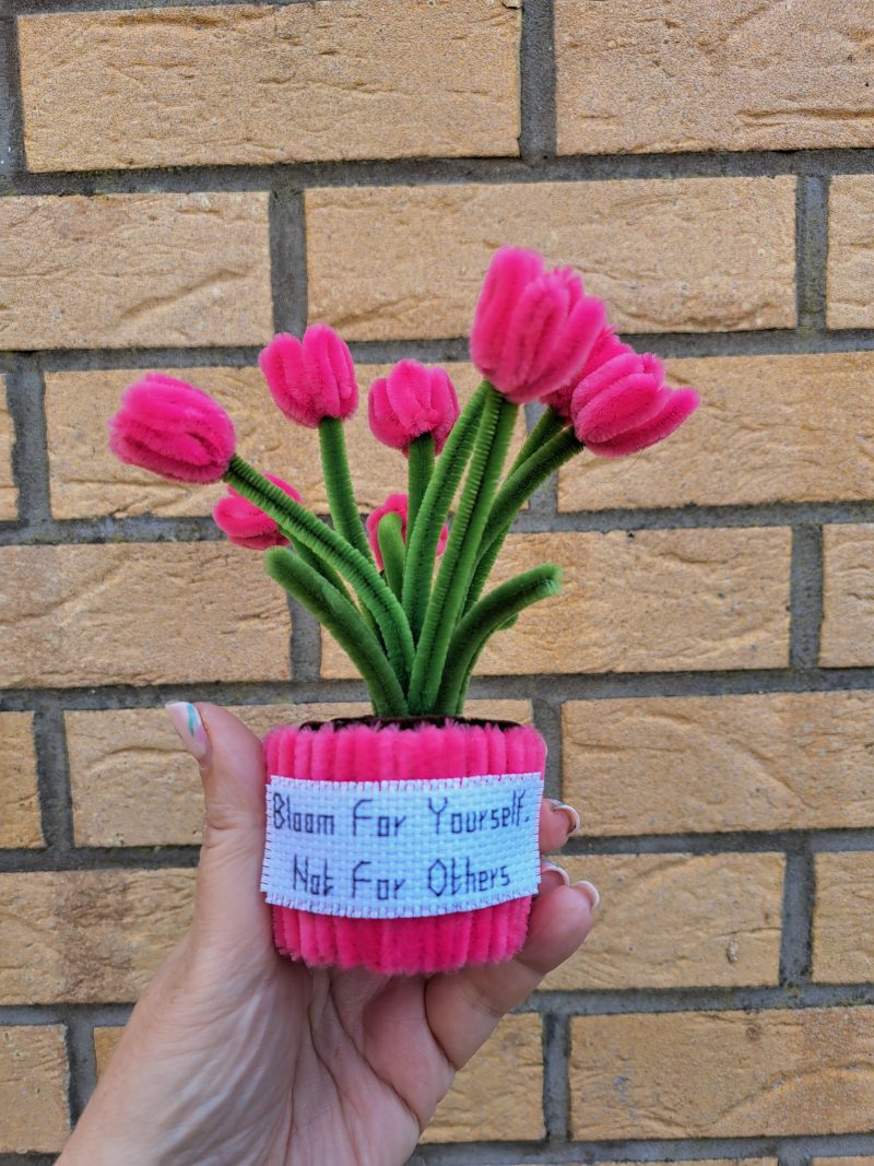 Handmade faux pink tulips crafted from pipe cleaners in a charming pot