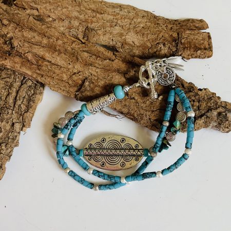 Turquoise and Tibetan silver three strand charm bracelet.