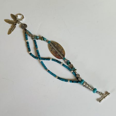 Turquoise and Tibetan silver three strand charm bracelet.