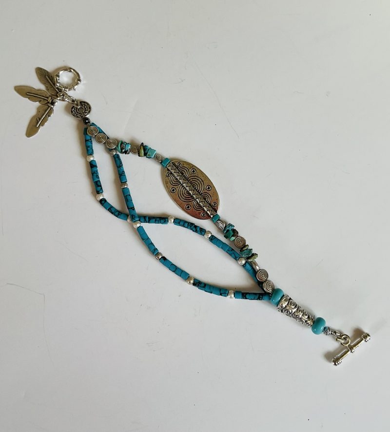 Turquoise and Tibetan silver three strand charm bracelet.