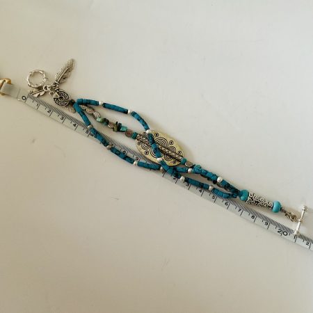 Turquoise and Tibetan silver three strand charm bracelet.