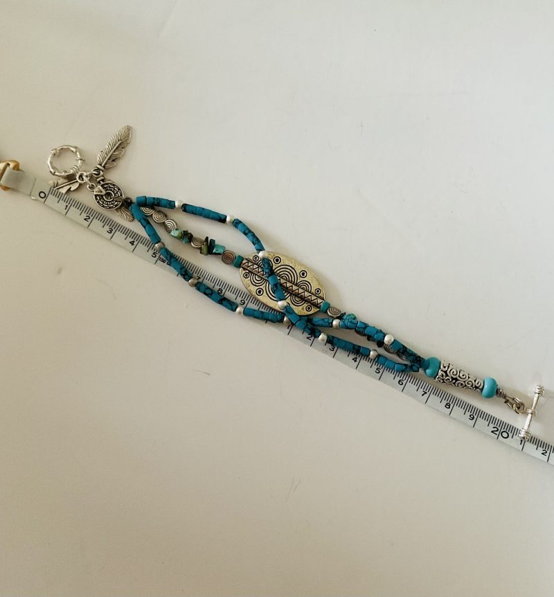 Turquoise and Tibetan silver three strand charm bracelet.