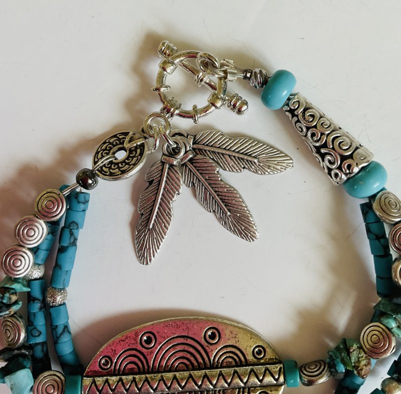 Turquoise and Tibetan silver three strand charm bracelet.