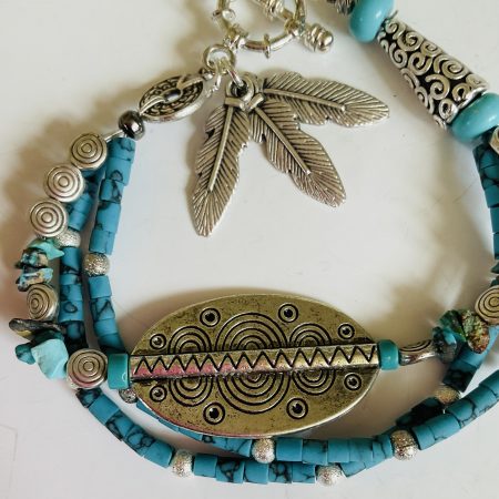 Turquoise and Tibetan silver three strand charm bracelet.