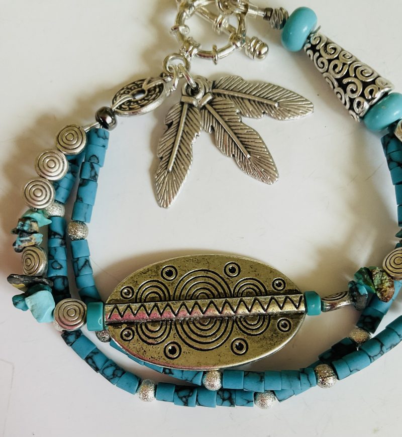 Turquoise and Tibetan silver three strand charm bracelet.