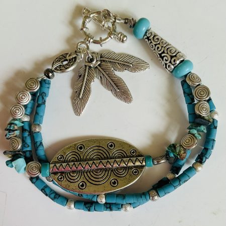 Turquoise and Tibetan silver three strand charm bracelet.