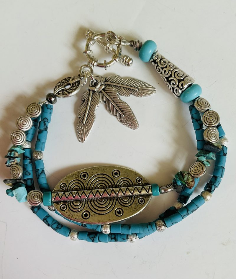 Turquoise and Tibetan silver three strand charm bracelet.