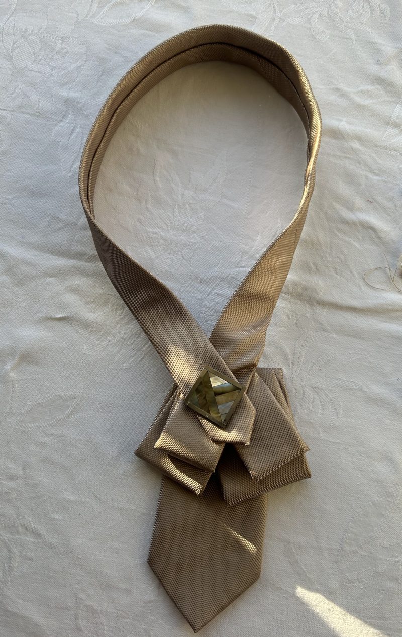 Elegant pendant accessory adorned with a mother pearl and wood and brooch