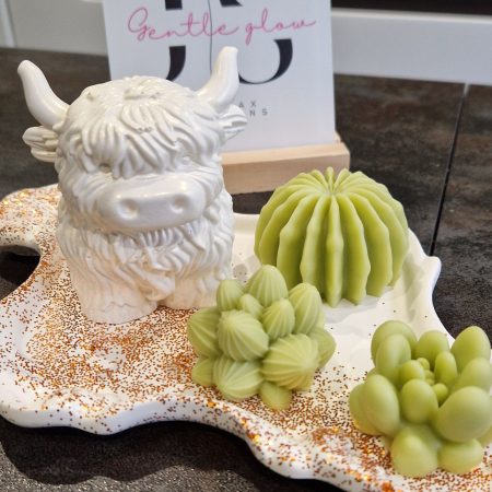 Handcrafted soy wax candle and plaster figure
