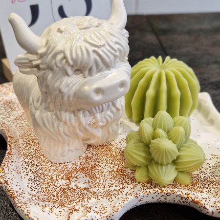 Handcrafted soy wax candle and plaster figure