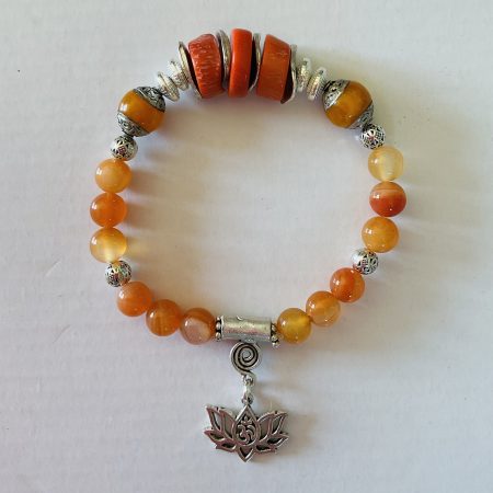 Stretch charm bracelet featuring deep sea coral, carnelian and Tibetan silver