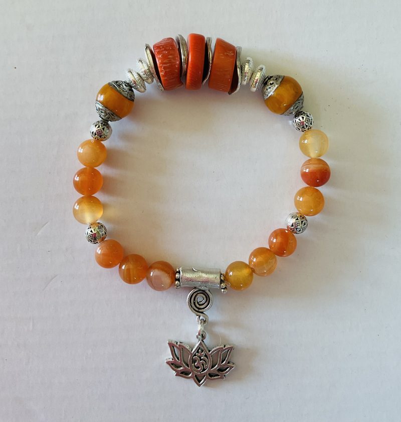 Stretch charm bracelet featuring deep sea coral, carnelian and Tibetan silver