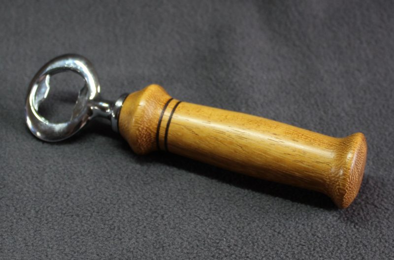 Hand turned Iroko bottle opener with a stainless steel opener