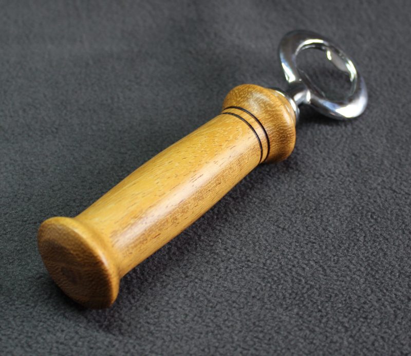 Hand turned Iroko bottle opener with a stainless steel opener