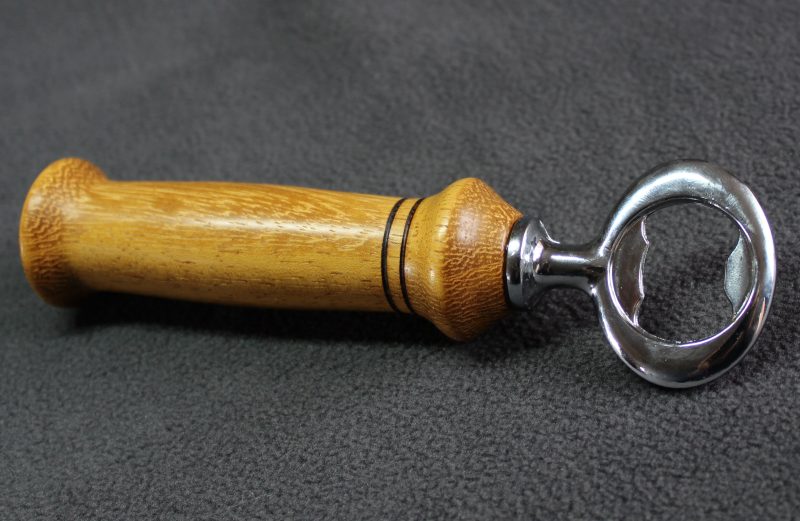 Hand turned Iroko bottle opener with a stainless steel opener
