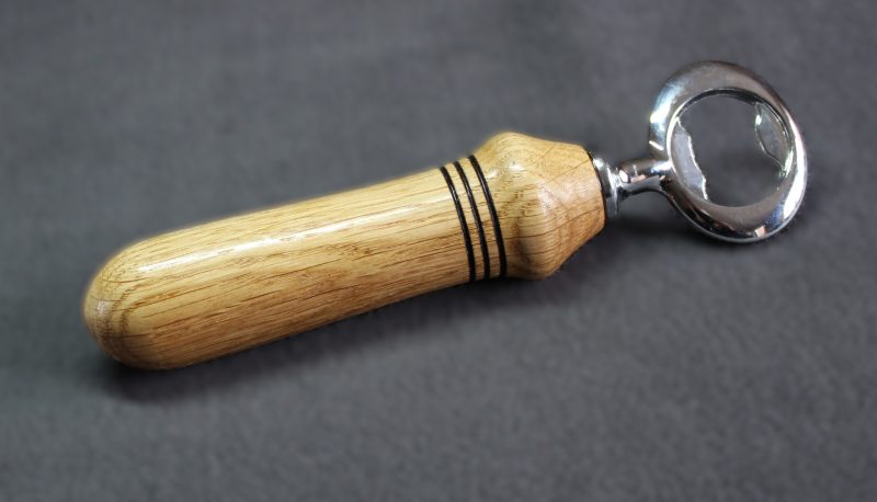 Hand turned oak bottle opener with a stainless steel opener