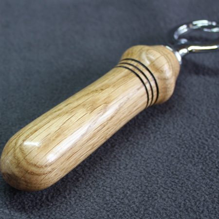 Hand turned oak bottle opener with a stainless steel opener