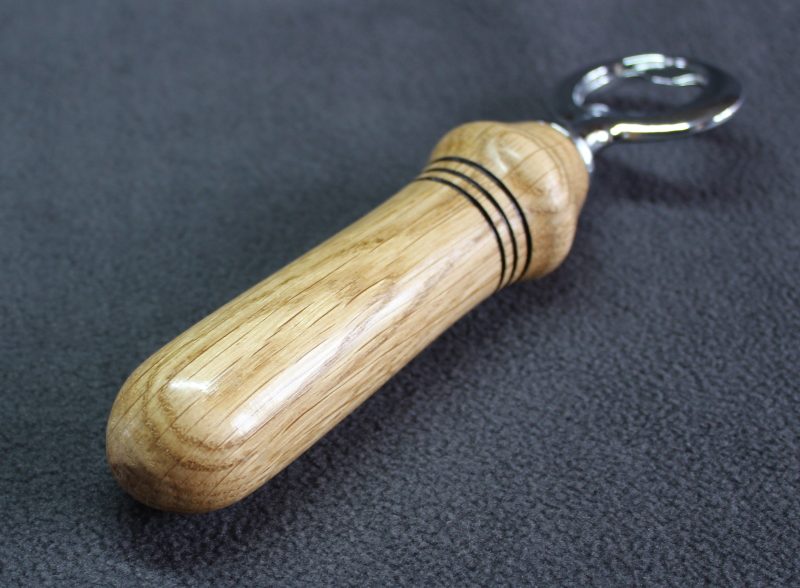 Hand turned oak bottle opener with a stainless steel opener
