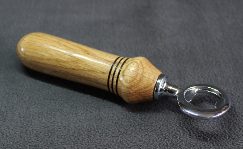 Hand turned oak bottle opener with a stainless steel opener