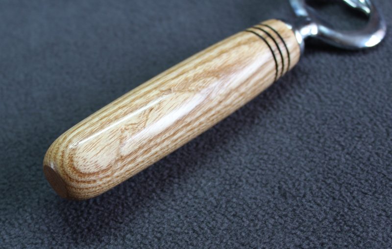 Hand turned ash bottle opener with a stainless steel opener