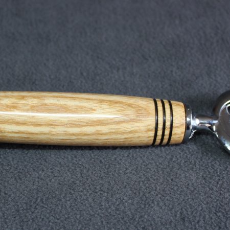 Hand turned ash bottle opener with a stainless steel opener