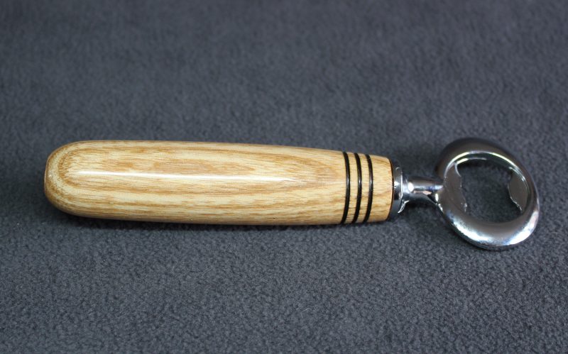 Hand turned ash bottle opener with a stainless steel opener
