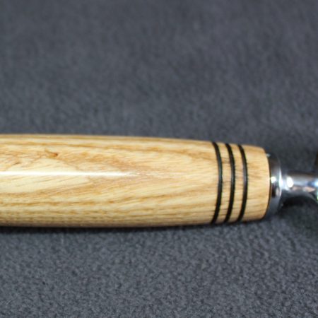 Hand turned ash bottle opener with a stainless steel opener