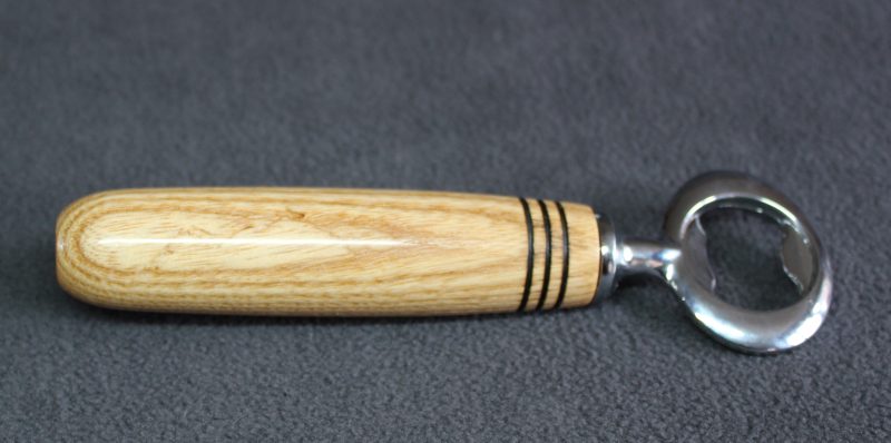 Hand turned ash bottle opener with a stainless steel opener