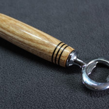 Hand turned ash bottle opener with a stainless steel opener