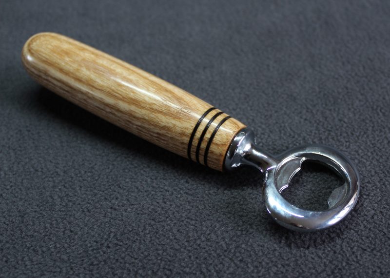 Hand turned ash bottle opener with a stainless steel opener
