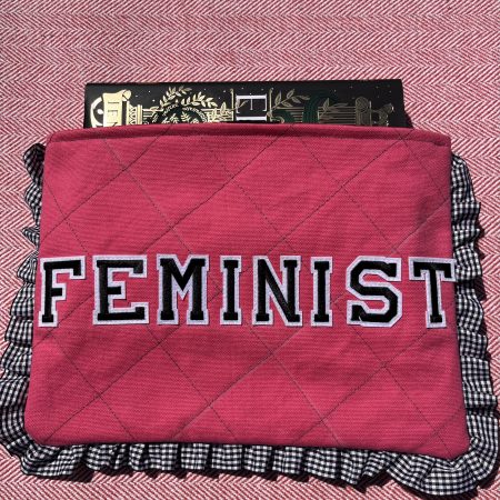 Hand sewn pink quilted book sleeve with slogan