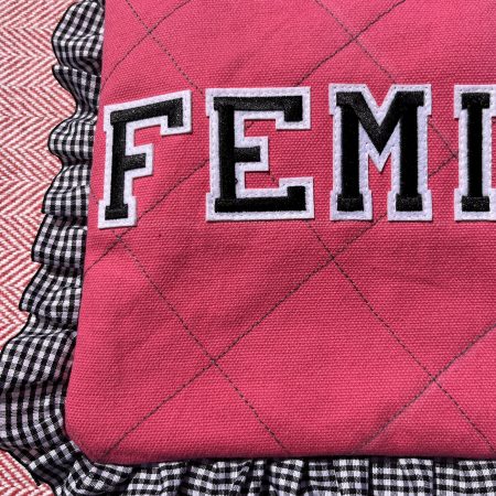 Hand sewn pink quilted book sleeve with slogan