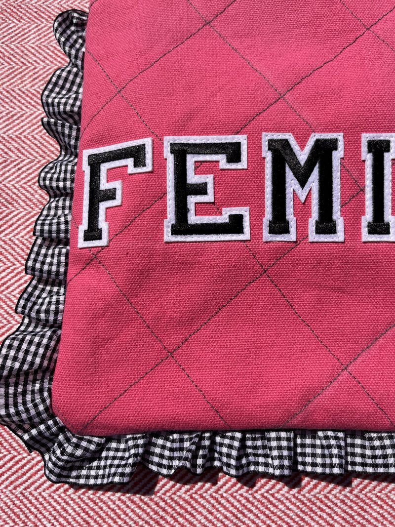 Hand sewn pink quilted book sleeve with slogan