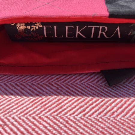 Hand sewn pink quilted book sleeve with slogan