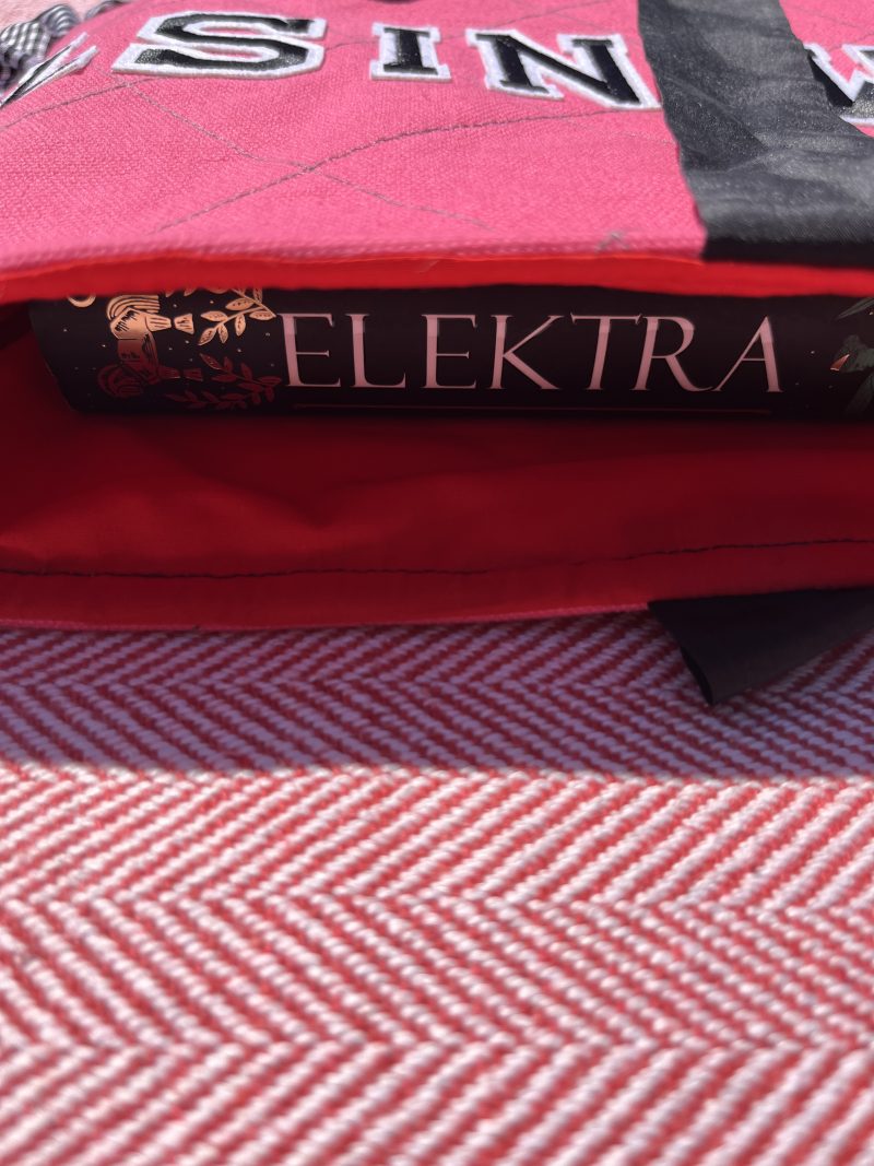 Hand sewn pink quilted book sleeve with slogan