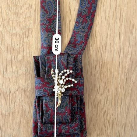Stylish Handmade necktie accessory in a vintage-style burgundy paisley printed silk tie paired with a crystal floral brooch