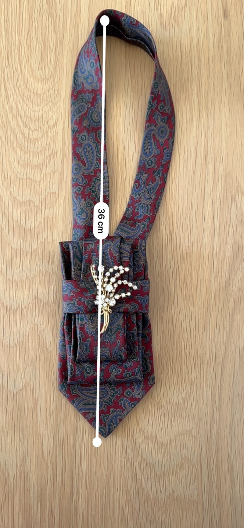 Stylish Handmade necktie accessory in a vintage-style burgundy paisley printed silk tie paired with a crystal floral brooch