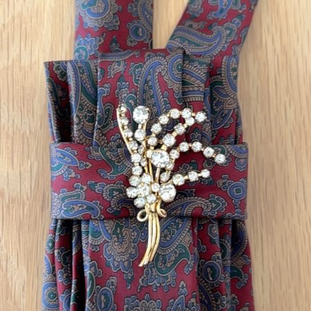 Stylish Handmade necktie accessory in a vintage-style burgundy paisley printed silk tie paired with a crystal floral brooch