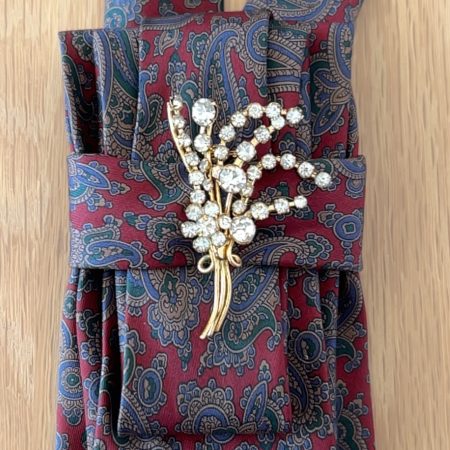 Stylish Handmade necktie accessory in a vintage-style burgundy paisley printed silk tie paired with a crystal floral brooch