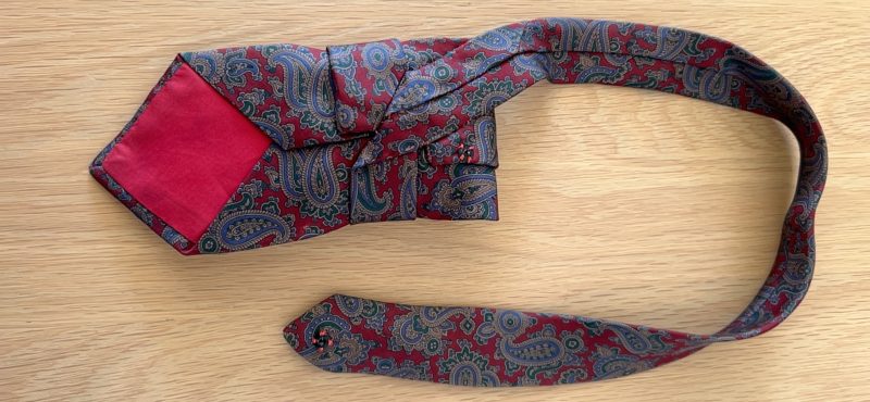 Stylish Handmade necktie accessory in a vintage-style burgundy paisley printed silk tie paired with a crystal floral brooch