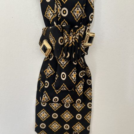 Handmade black silk necktie with a gold and white geometric pattern and decorative gold accents necktie.