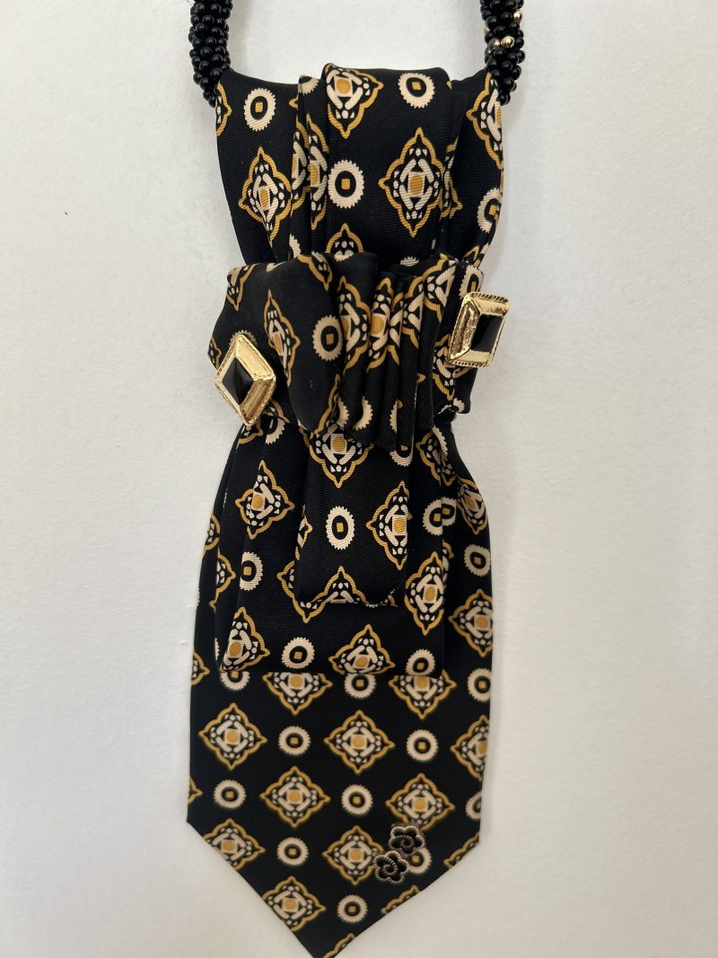 Handmade black silk necktie with a gold and white geometric pattern and decorative gold accents necktie.